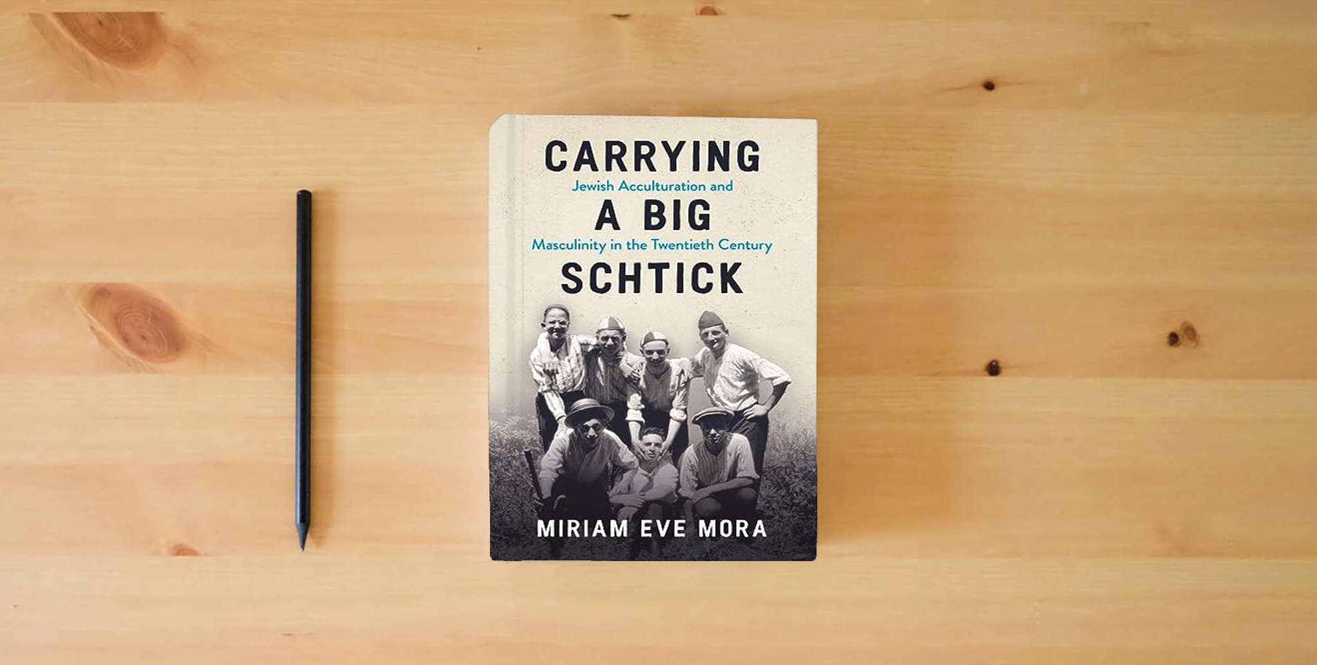 The book Carrying a Big Schtick: Jewish Acculturation and Masculinity in the Twentieth Century is on the table