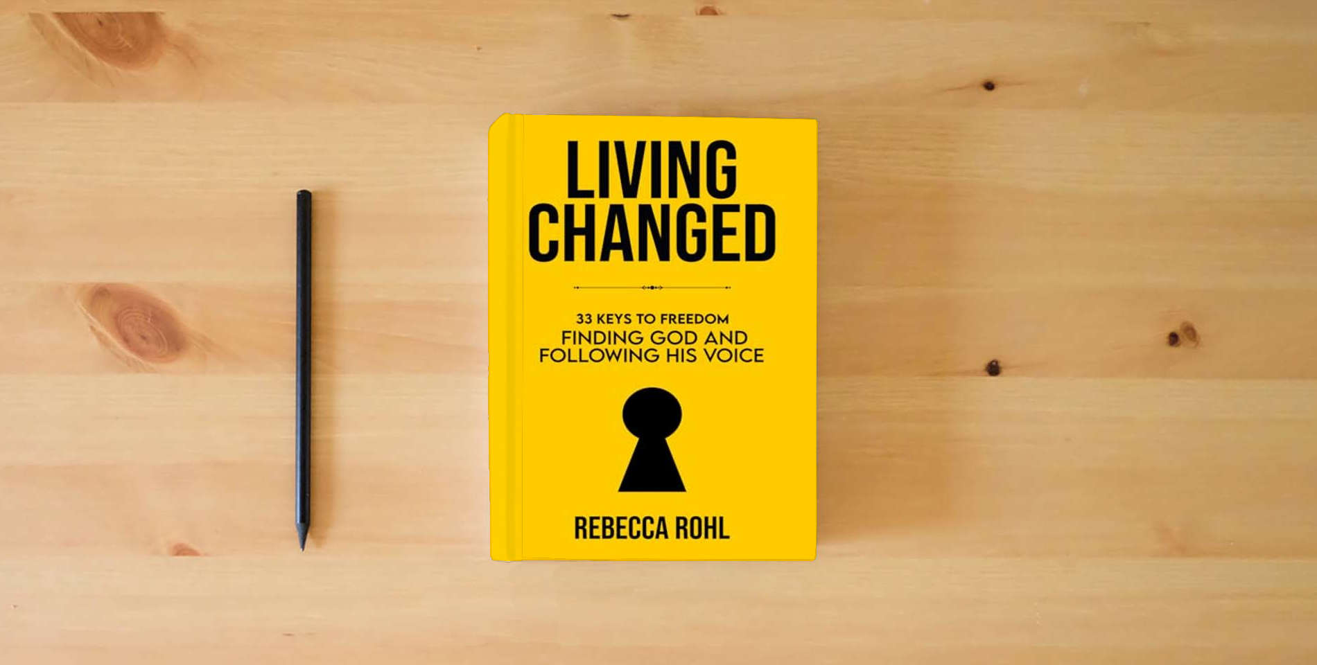The book Living Changed: 33 Keys to Freedom: Finding God and Following His Voice is on the table