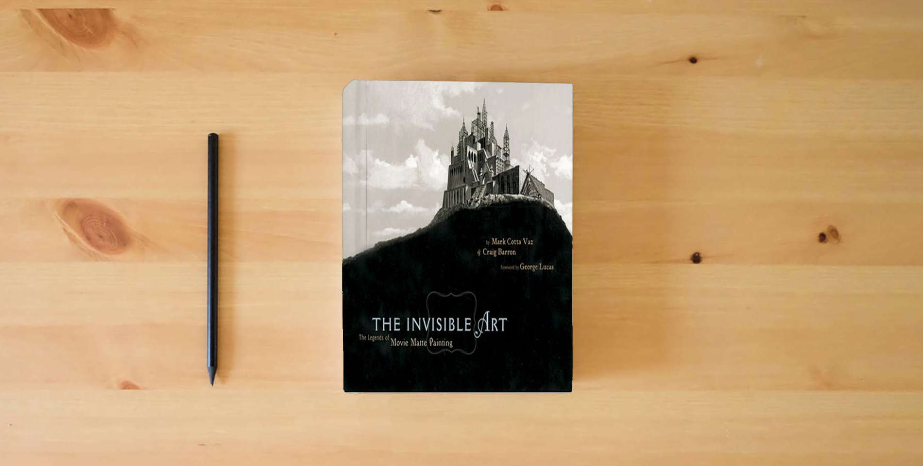 The book The Invisible Art: The Legends of Movie Matte Painting is on the table