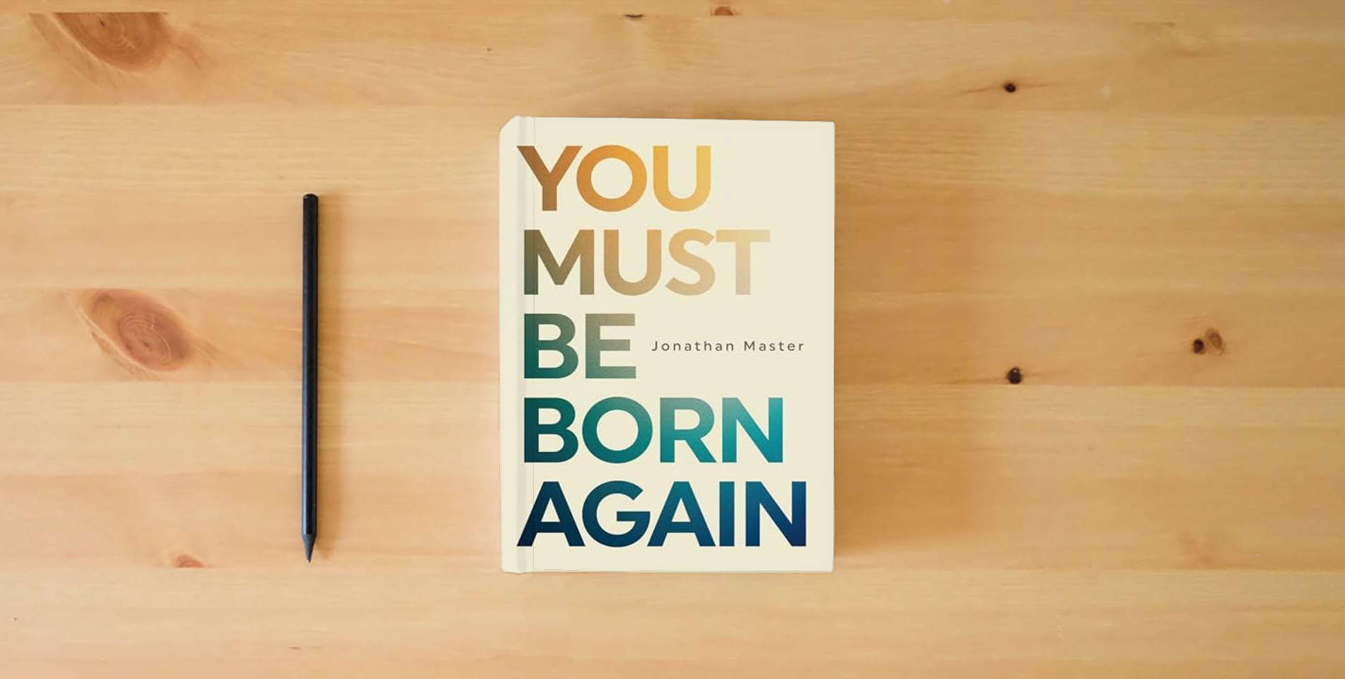 The book You Must Be Born Again is on the table