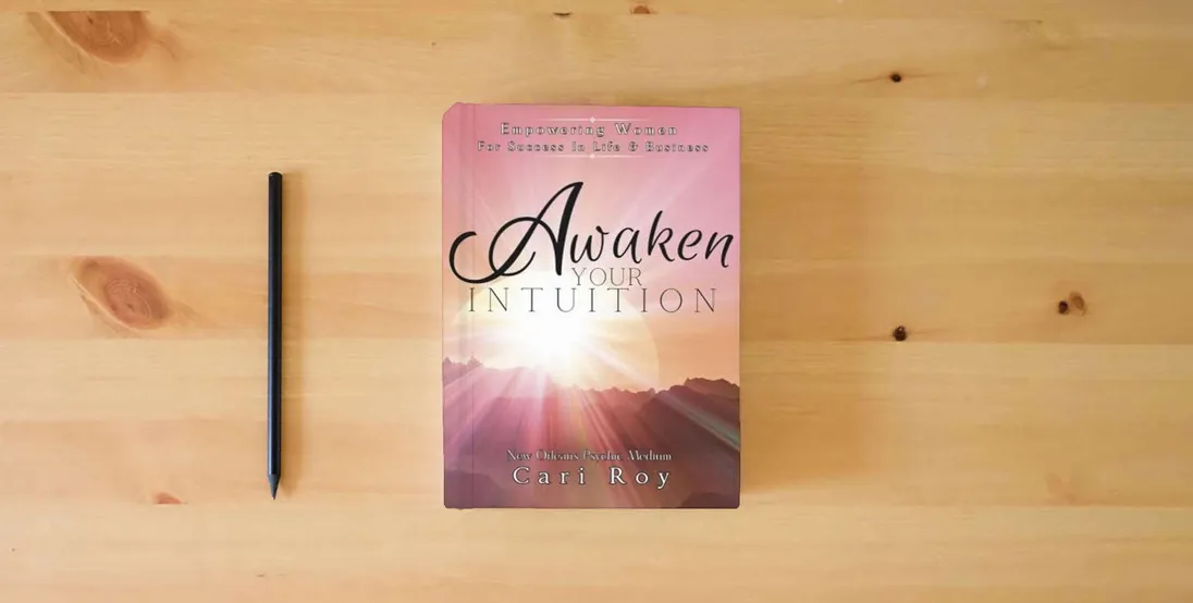 The book Awaken Your Intuition: Empowering Women For Success In Life & Business} is on the table