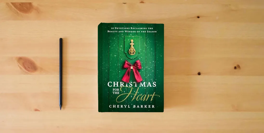 The book Christmas for the Heart: 25 Devotions Reclaiming the Beauty and Wonder of the Season} is on the table