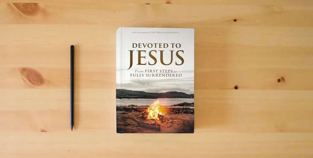 The book Devoted to Jesus: From First Steps to Fully Surrendered} is on the table