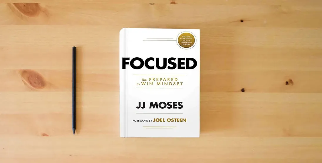 The book Focused: The Prepared to Win Mindset} is on the table