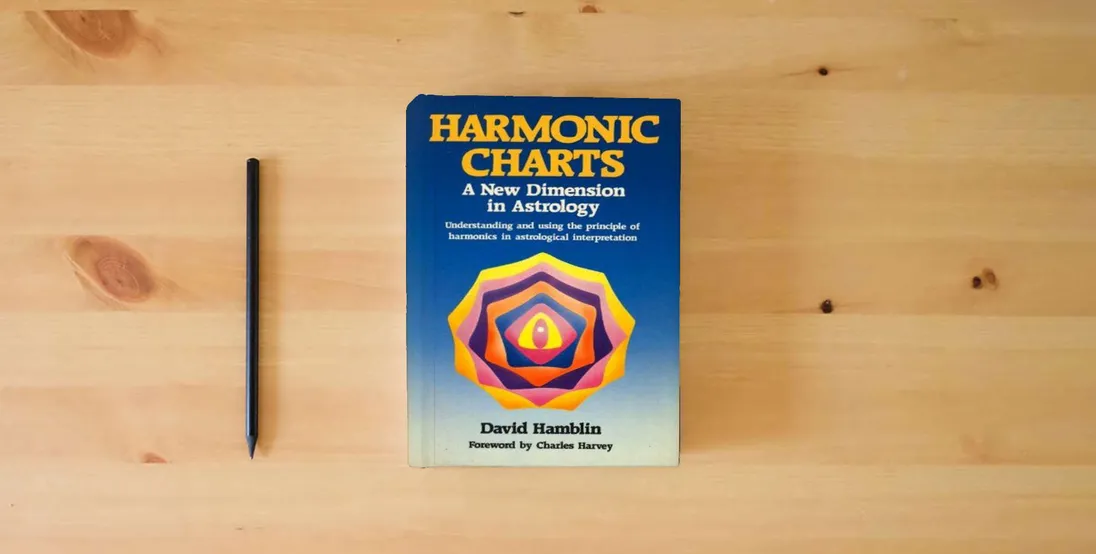 The book Harmonic Charts: A New Dimension in Astrology} is on the table