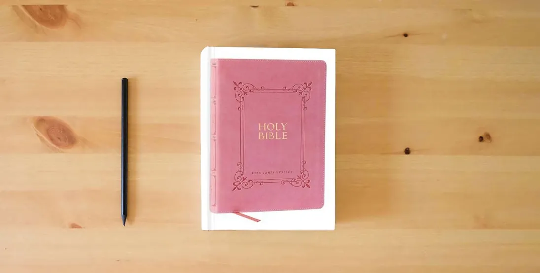 The book KJV Holy Bible: Large Print with 53,000 Center-Column Cross References, Pink Leathersoft, Red Letter, Comfort Print: King James Version} is on the table