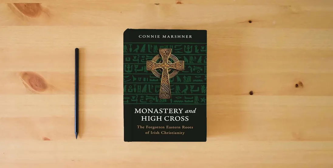The book Monastery and High Cross: The Forgotten Eastern Roots of Irish Christianity} is on the table