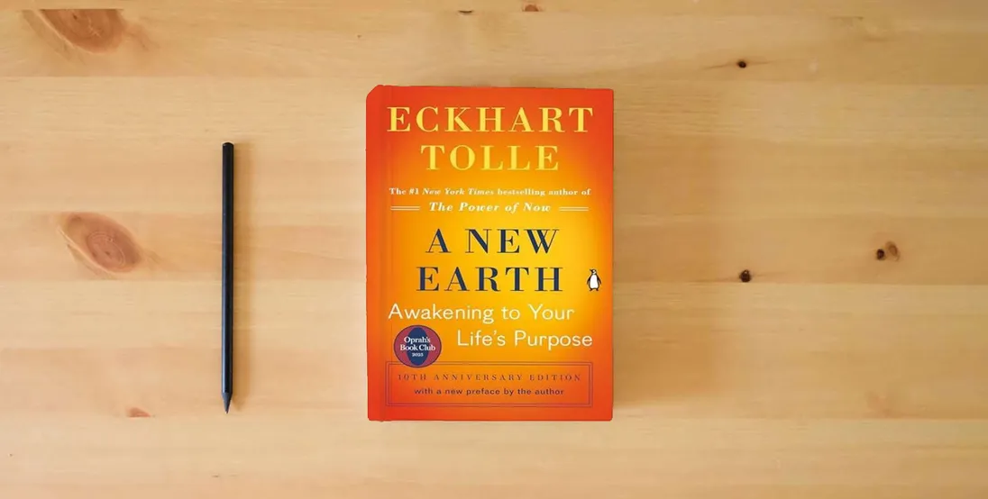 The book A New Earth: Awakening to Your Life's Purpose (Oprah's Book Club, Selection 61)} is on the table