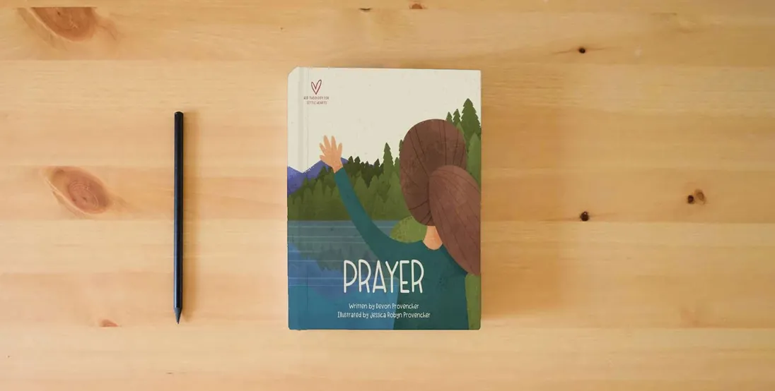 The book Prayer (Big Theology for Little Hearts)} is on the table