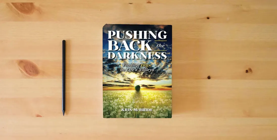 The book Pushing Back the Darkness: Finding Hope in Life's Valleys} is on the table