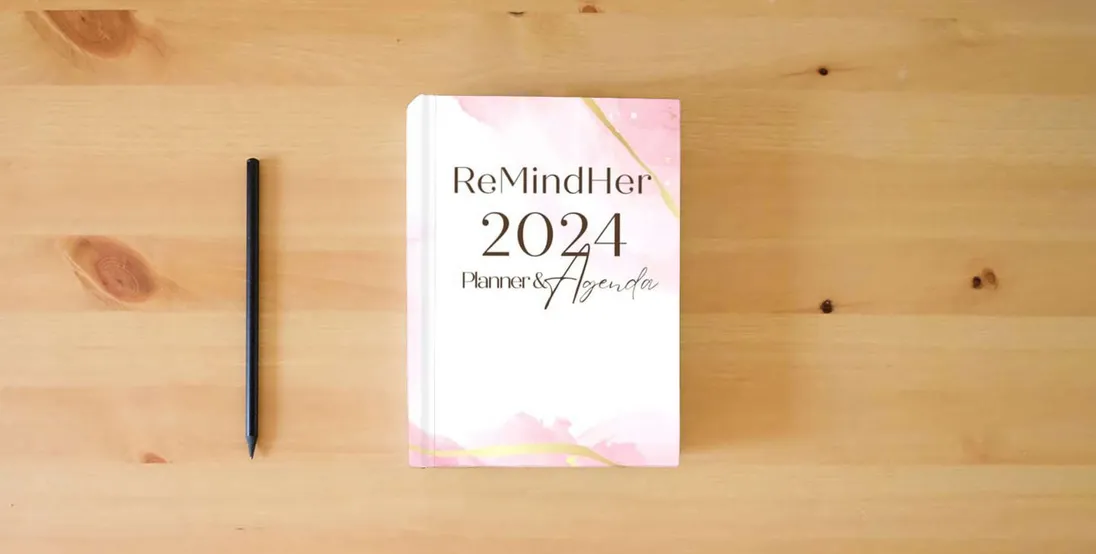 The book ReMindHer 2024 Journal & Agenda} is on the table