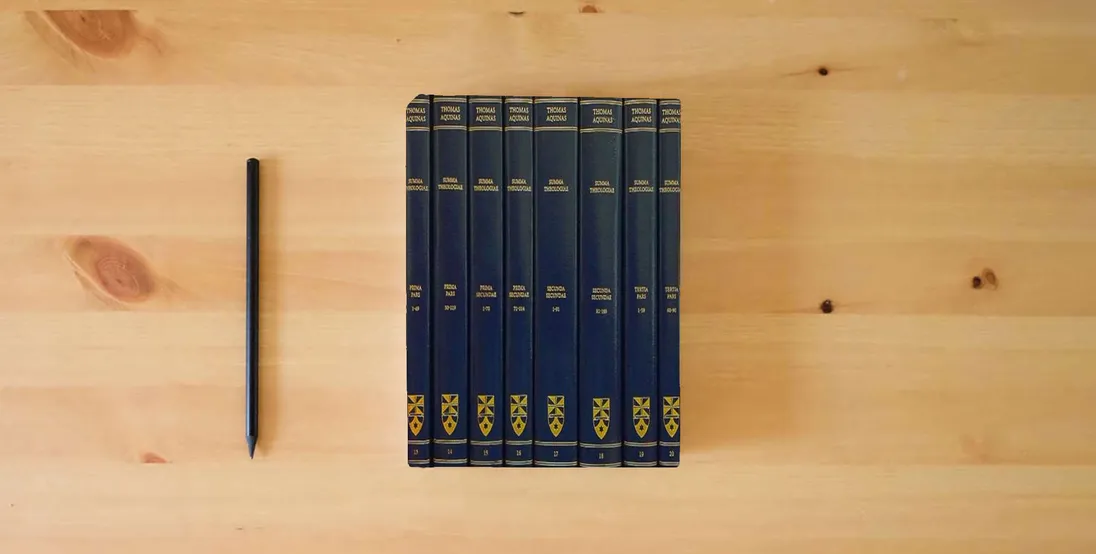 The book Summa Theologiae: Complete Set} is on the table