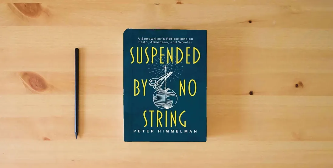 The book Suspended by No String: A Songwriter's Reflections on Faith, Aliveness, and Wonder} is on the table