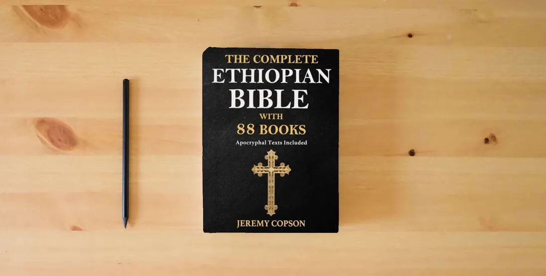 The book THE COMPLETE ETHIOPIAN BIBLE WITH 88 BOOKS: Apocryphal Texts Included} is on the table
