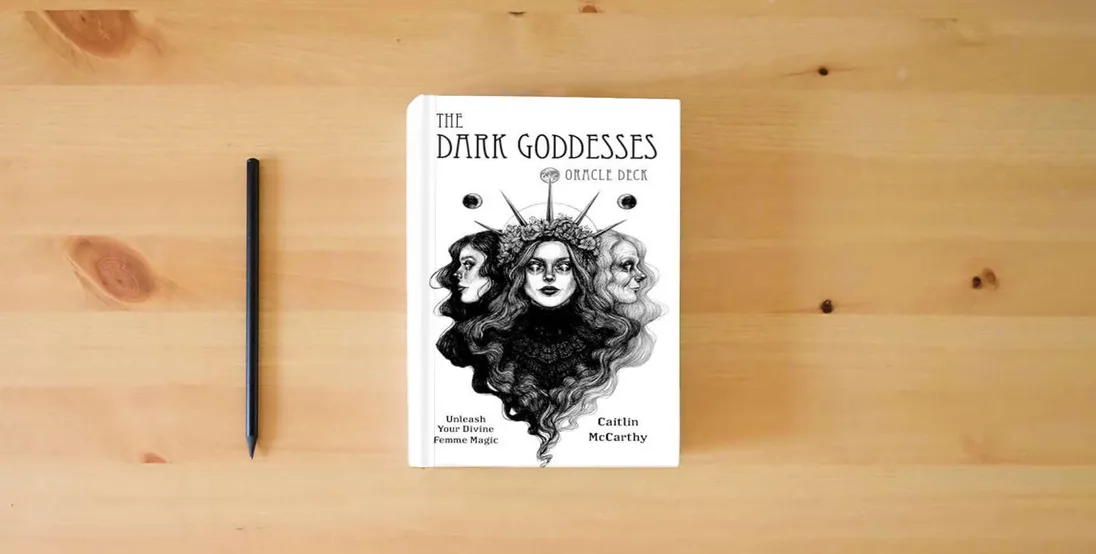 The book The Dark Goddesses Oracle Deck: Unleash Your Divine Femme Magic} is on the table