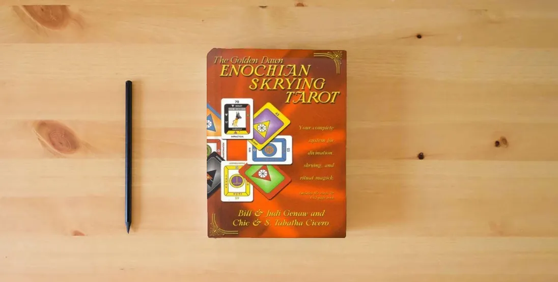 The book The Golden Dawn Enochian Skrying Tarot: Your Complete System for Divination, Skrying and Ritual Magick} is on the table