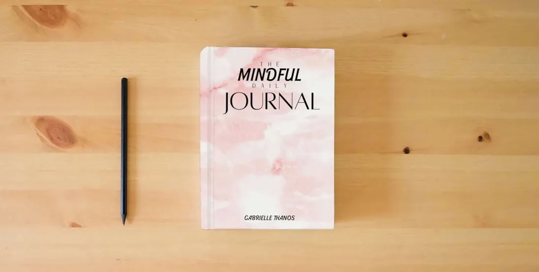The book The Mindful Daily Journal} is on the table