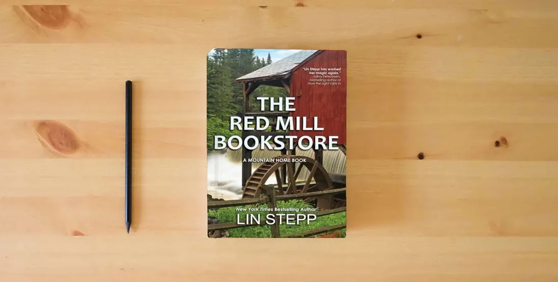 The book The Red Mill Bookstore} is on the table