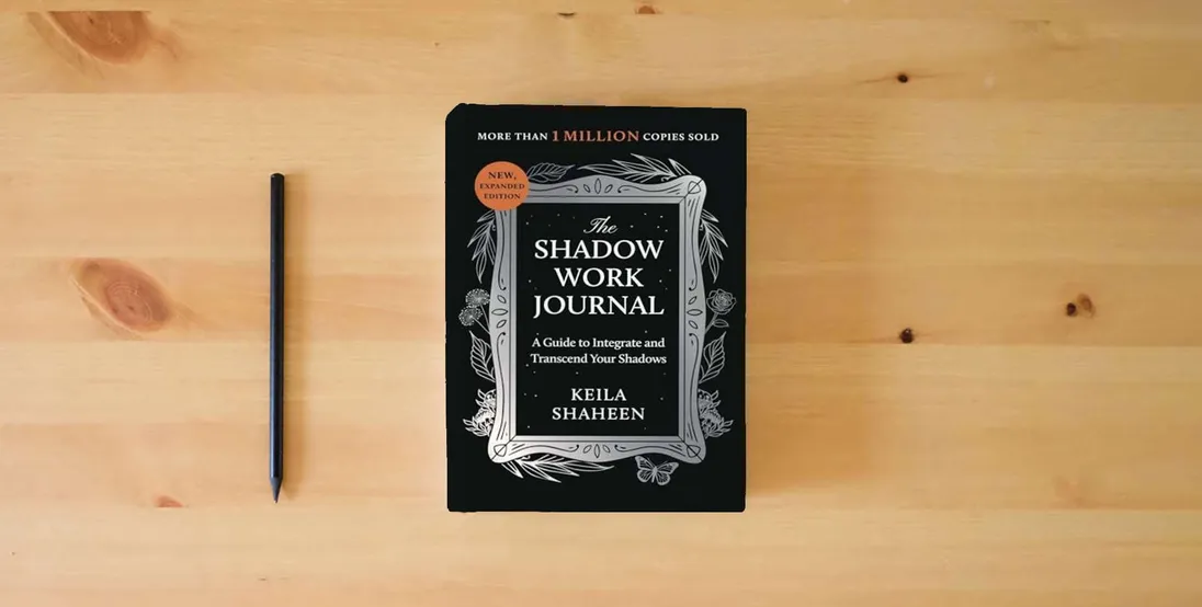 The book The Shadow Work Journal: A Guide to Integrate and Transcend Your Shadows} is on the table