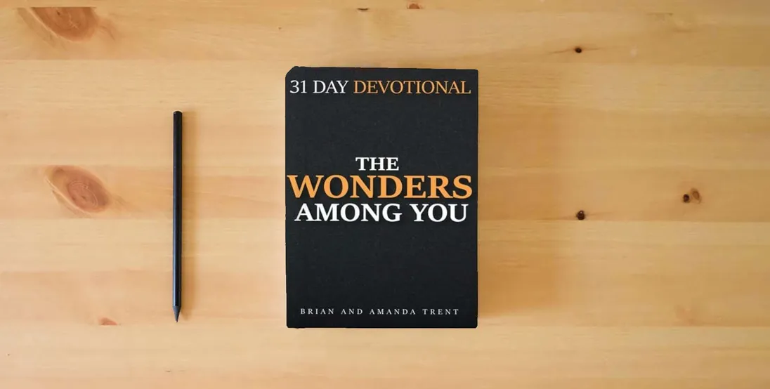 The book The Wonders Among You: 31 Day Devotional} is on the table