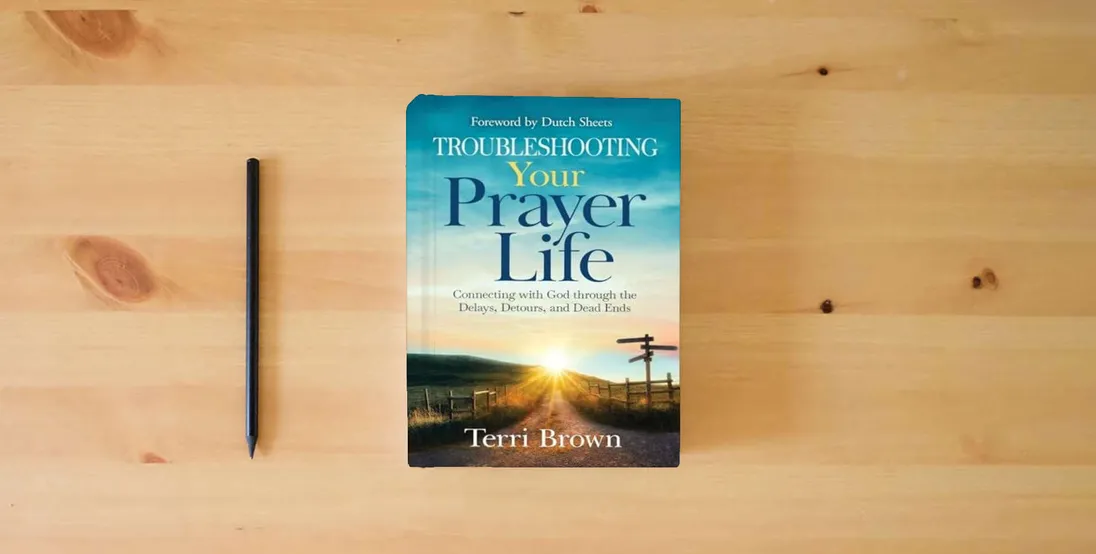 The book Troubleshooting Your Prayer Life: Connecting with God through the Delays, Detours, and Dead Ends} is on the table