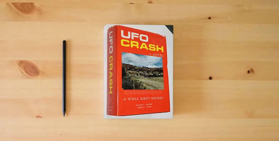 The book UFO Crash at Aztec: A Well Kept Secret} is on the table