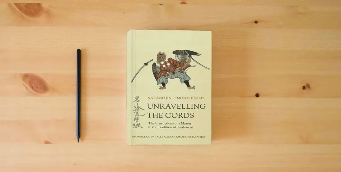 The book Unravelling the Cords - The Instructions of a Master in the Tradition of Taisha-ryū} is on the table