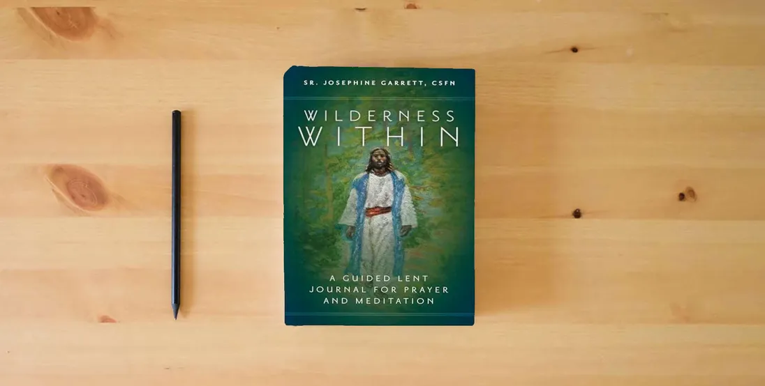 The book Wilderness Within: A Guided Lent Journal for Prayer and Meditation} is on the table