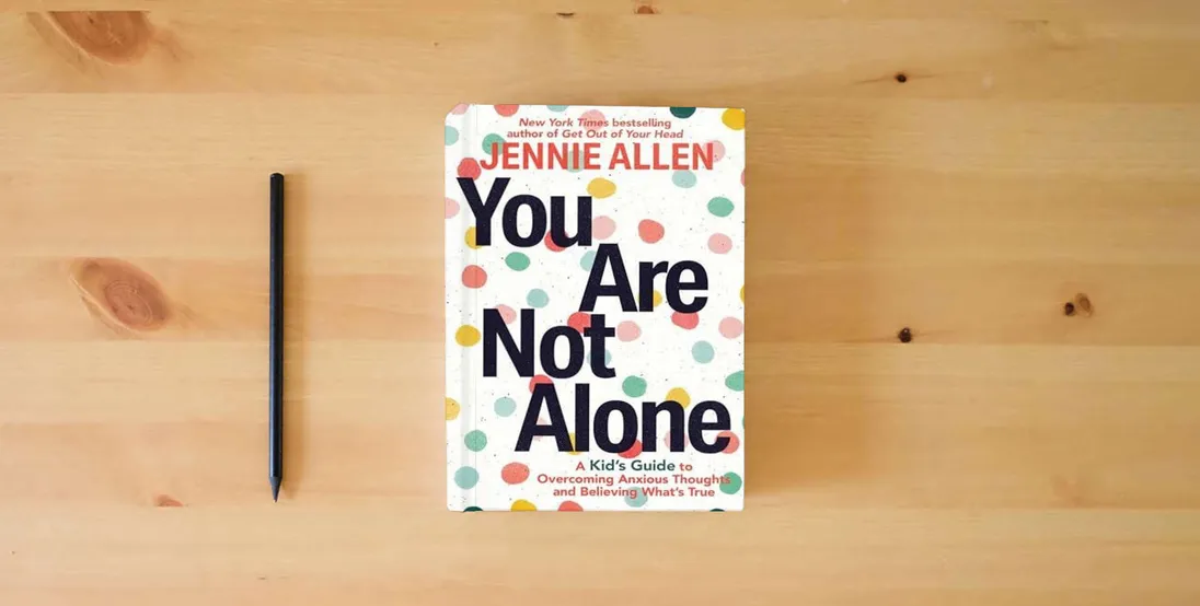 The book You Are Not Alone: A Kid's Guide to Overcoming Anxious Thoughts and Believing What's True} is on the table
