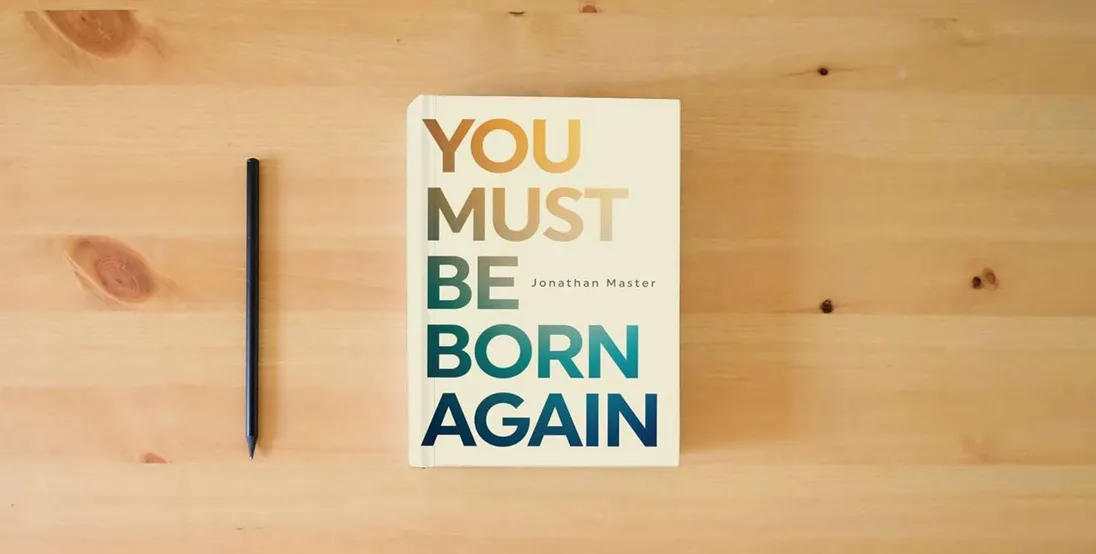 The book You Must Be Born Again} is on the table